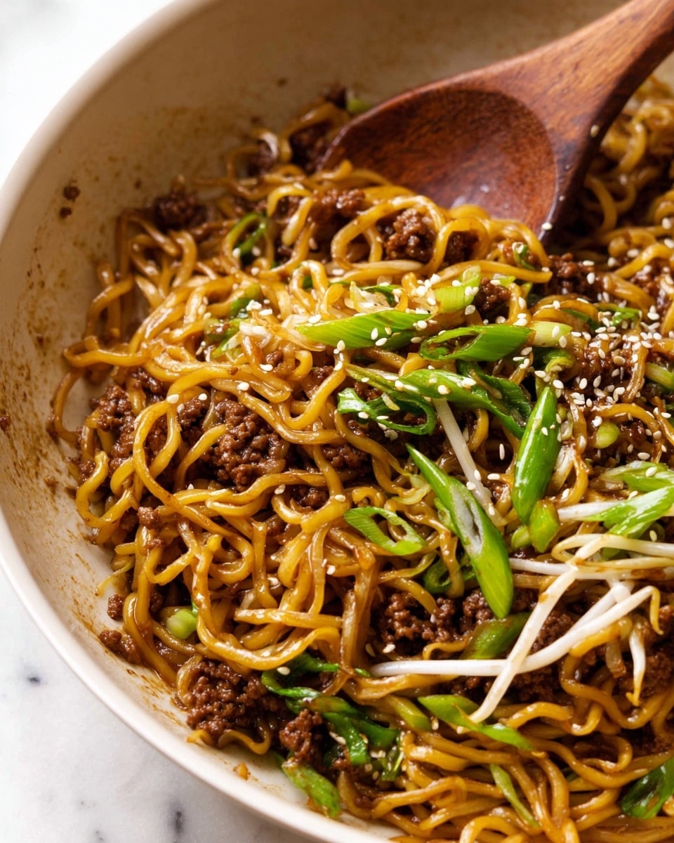 The image shows a bowl filled with several layers of cooked ramen noodles, dark brown, glossy minced meat, and crunchy bean sprouts mixed together. On top, thinly sliced bright green scallions and white sesame seeds are spread evenly as garnish. A wooden spoon rests inside the bowl, partially submerged in the noodles. The bowl has a natural, light wood tone, and the background is white marble. Photo taken with an iphone --ar 4:5 --v 7